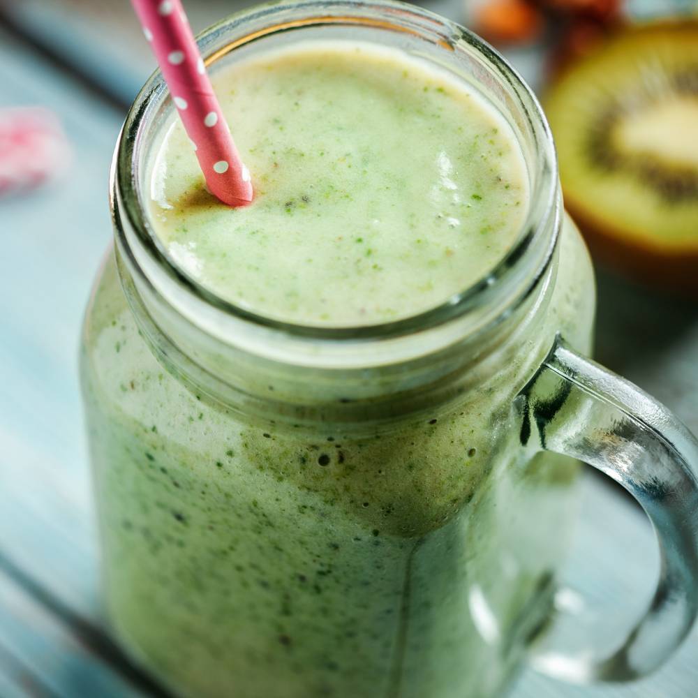 The greens powder measured out in its scoop